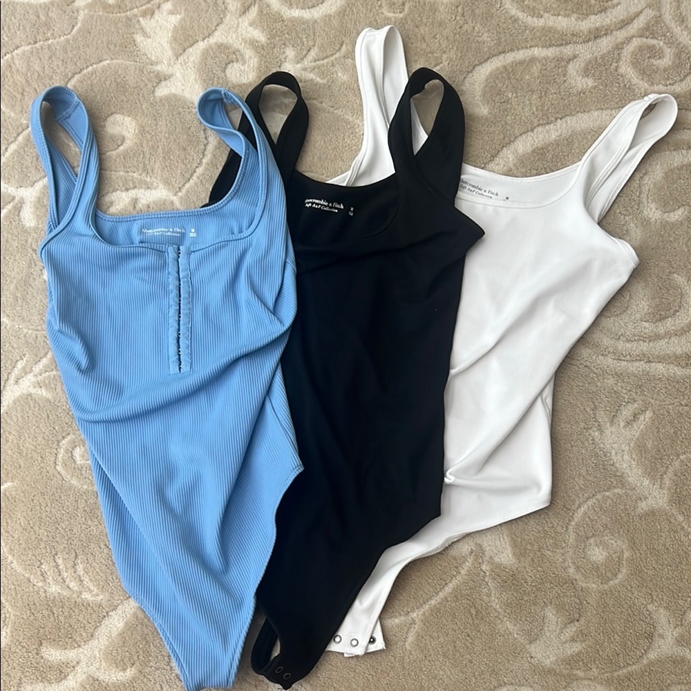 Blue, Black, and White Bodysuits